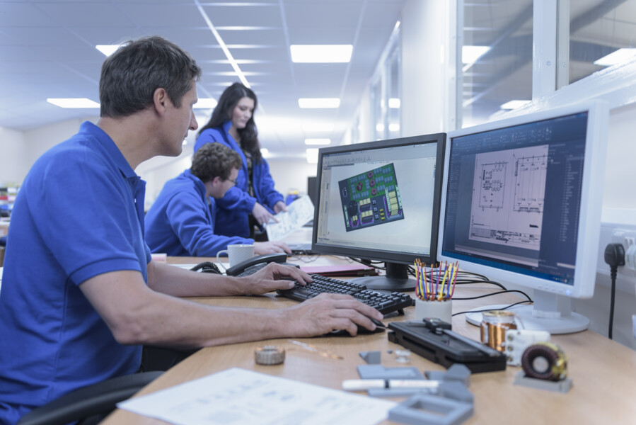 Engineers inspecting industrial pipeline valves at facility for fluid handling systems